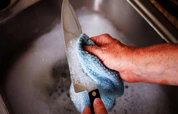 Washing The Knife With Warm Water and Soap